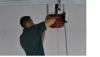 Technician installing a Liftmaster garage door opener in Millcreek, UT